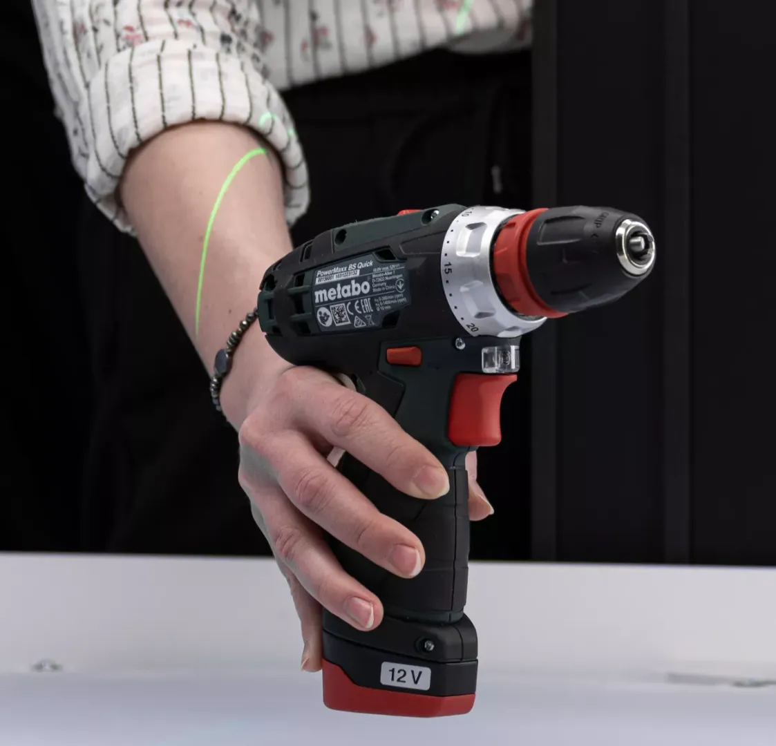 Primer plano de un taladro Metabo sostenido con la mano
